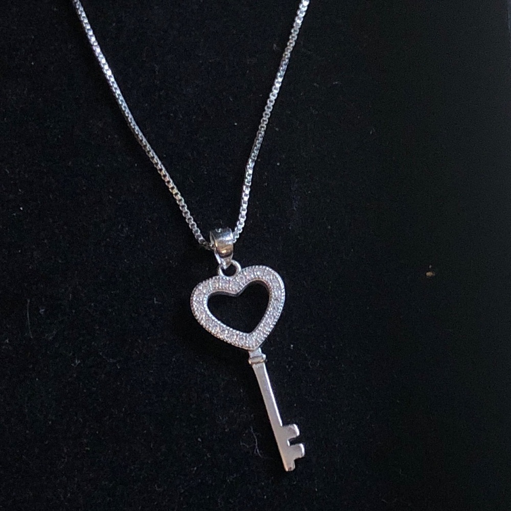 Silver key necklace.